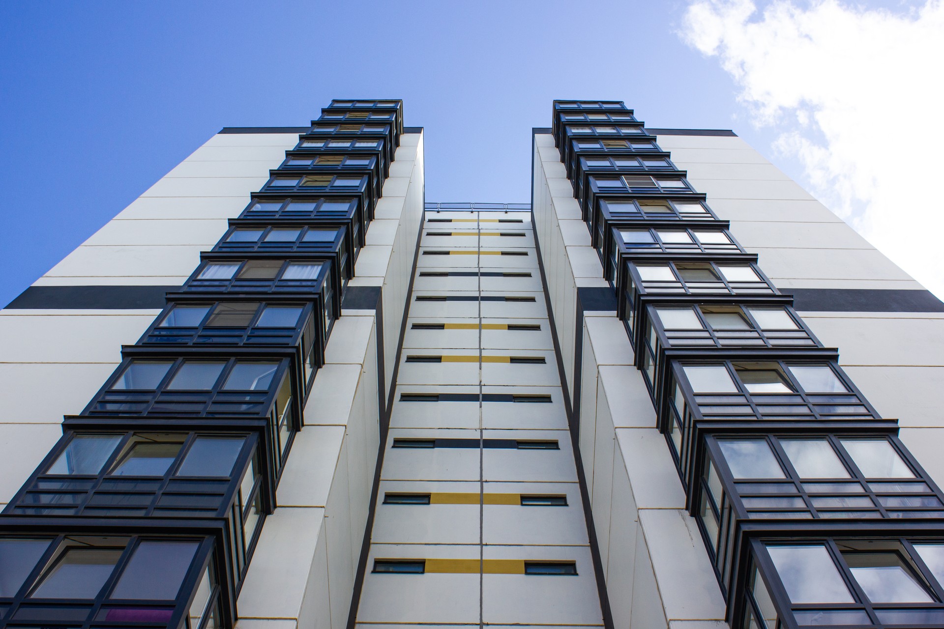 Multi-apartment modern house. Residential building, residential complex, apartments. Architecture, house design with balconies. House construction industry, industry. Renting, renting housing.